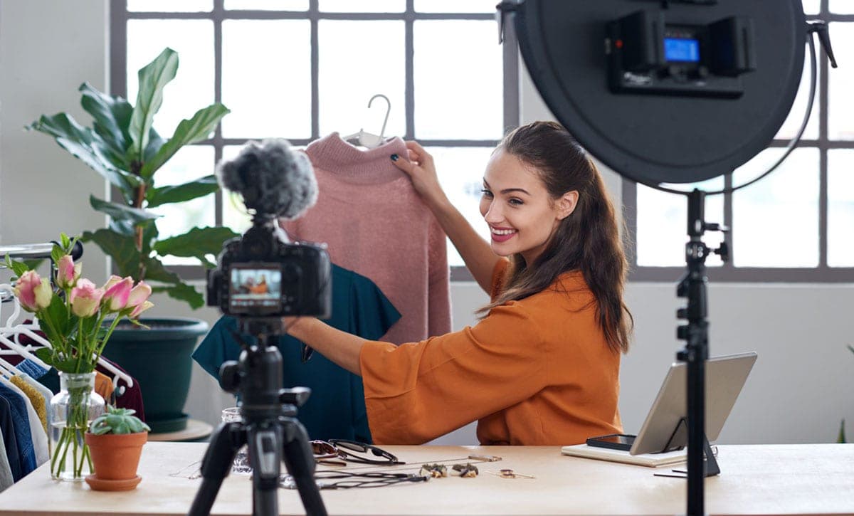 A live shopping presenter recording in a home studio